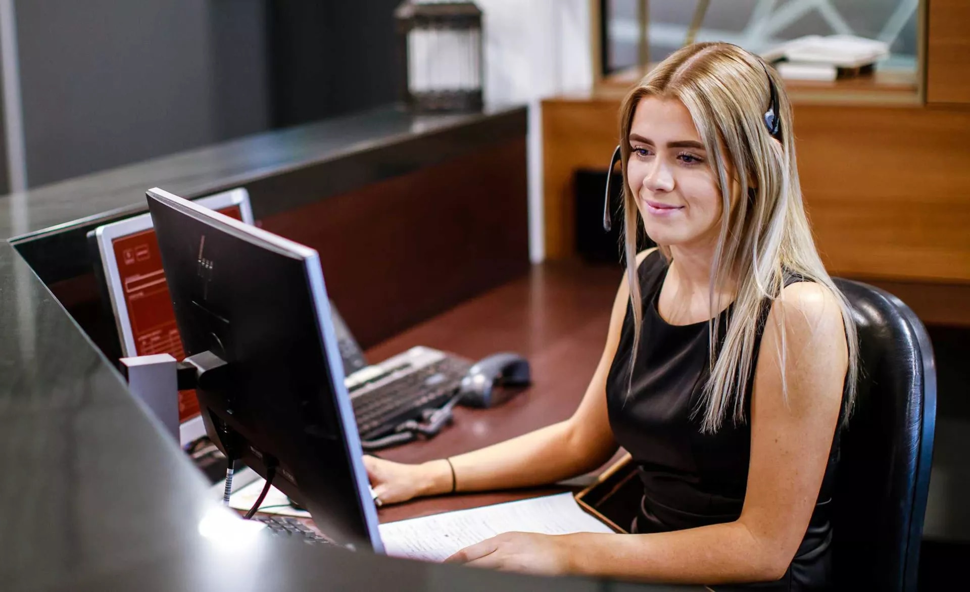 Receptionist helping clients at the front desk