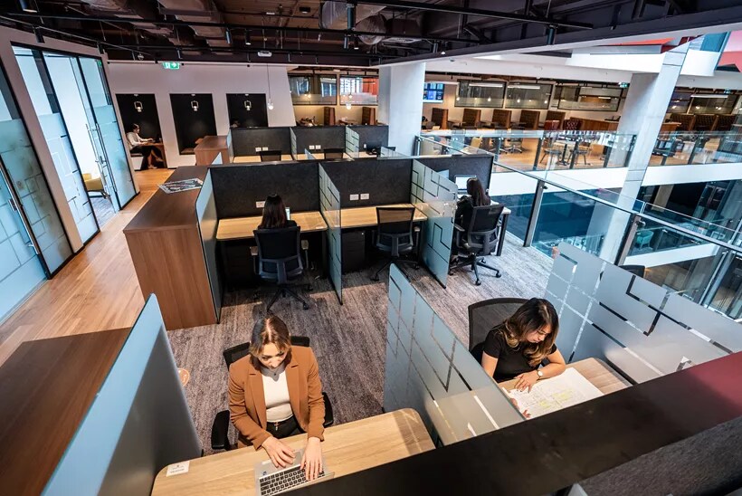High angle of people enjoying their time in a modern coworking space working on dedicated desks in Servcorp 3 Parramatta Square