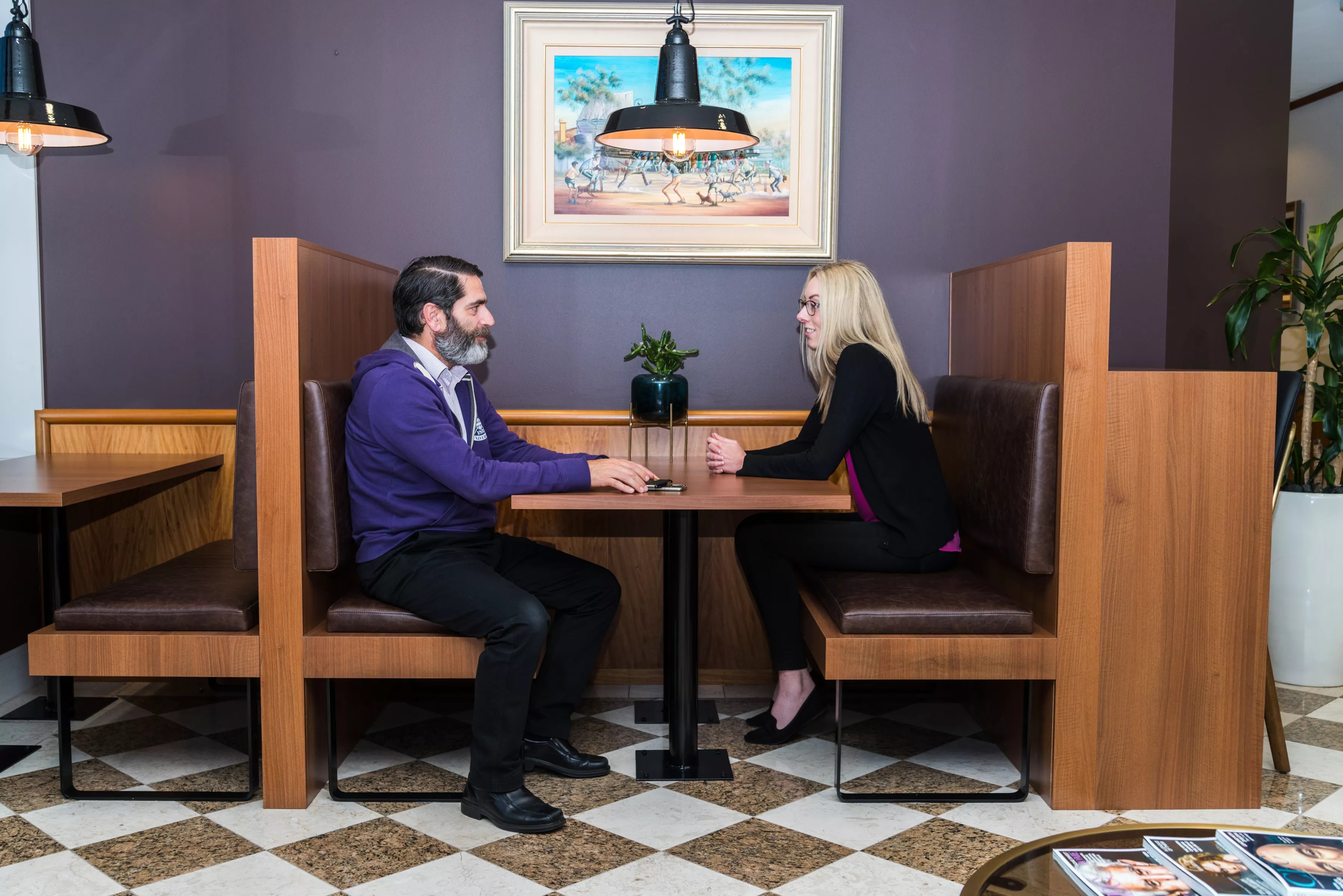 Clients working in a modern coworking space hotdesk booths, in Servcorp 140 St Georges Terrace Perth