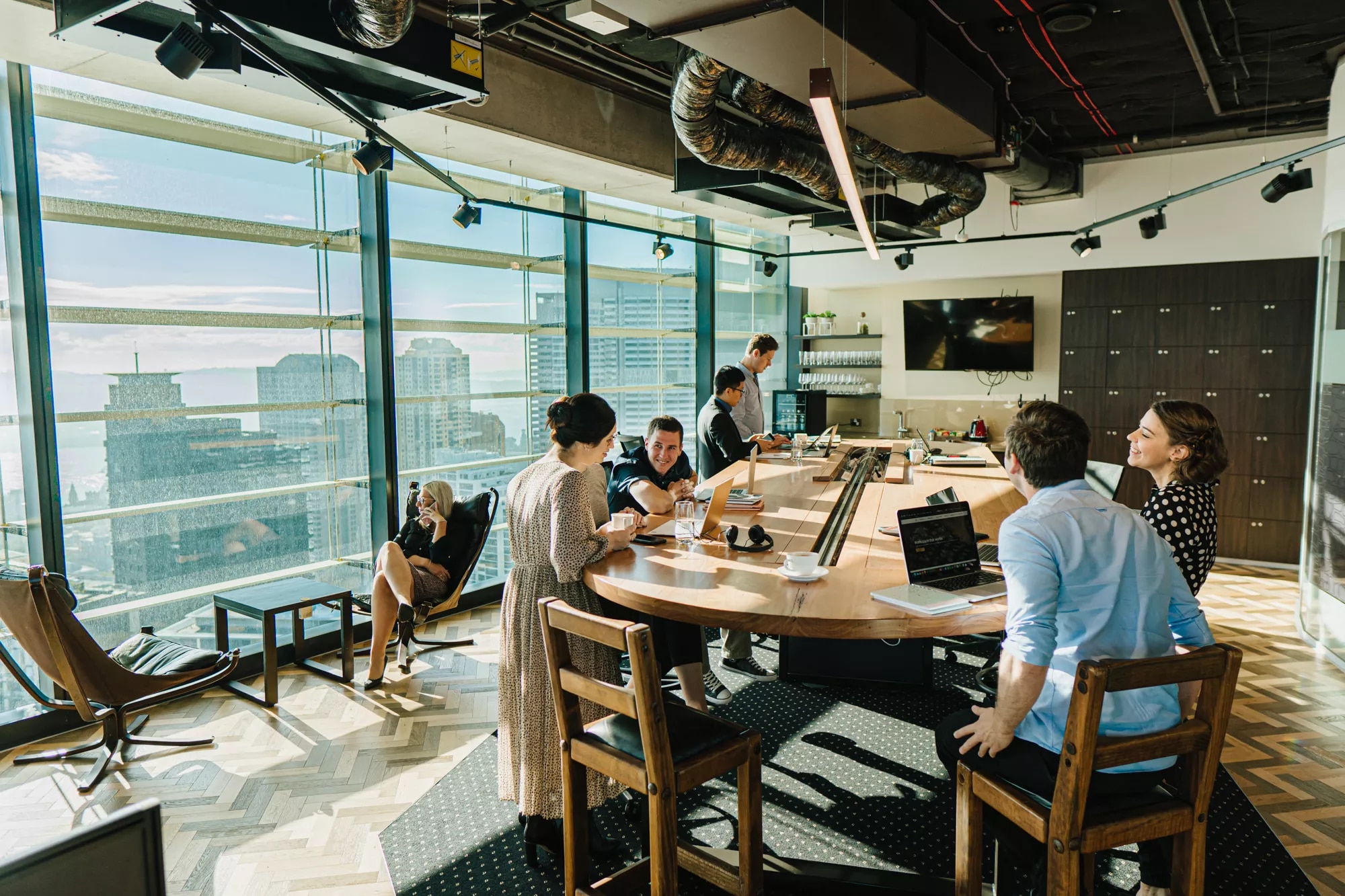 Close up on people working in a coworking space on a large table and impressive view in Barangaroo, tower 1