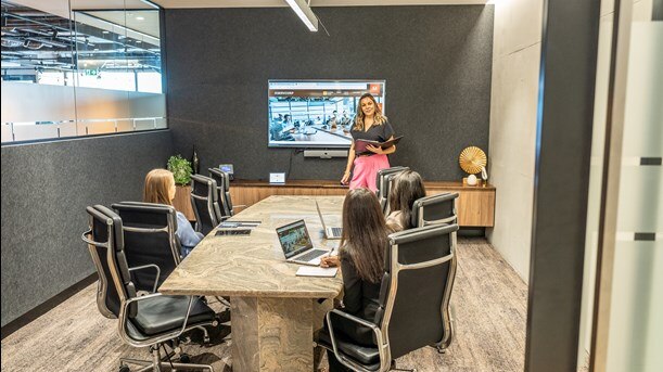 A team of corporate workers using a conference room