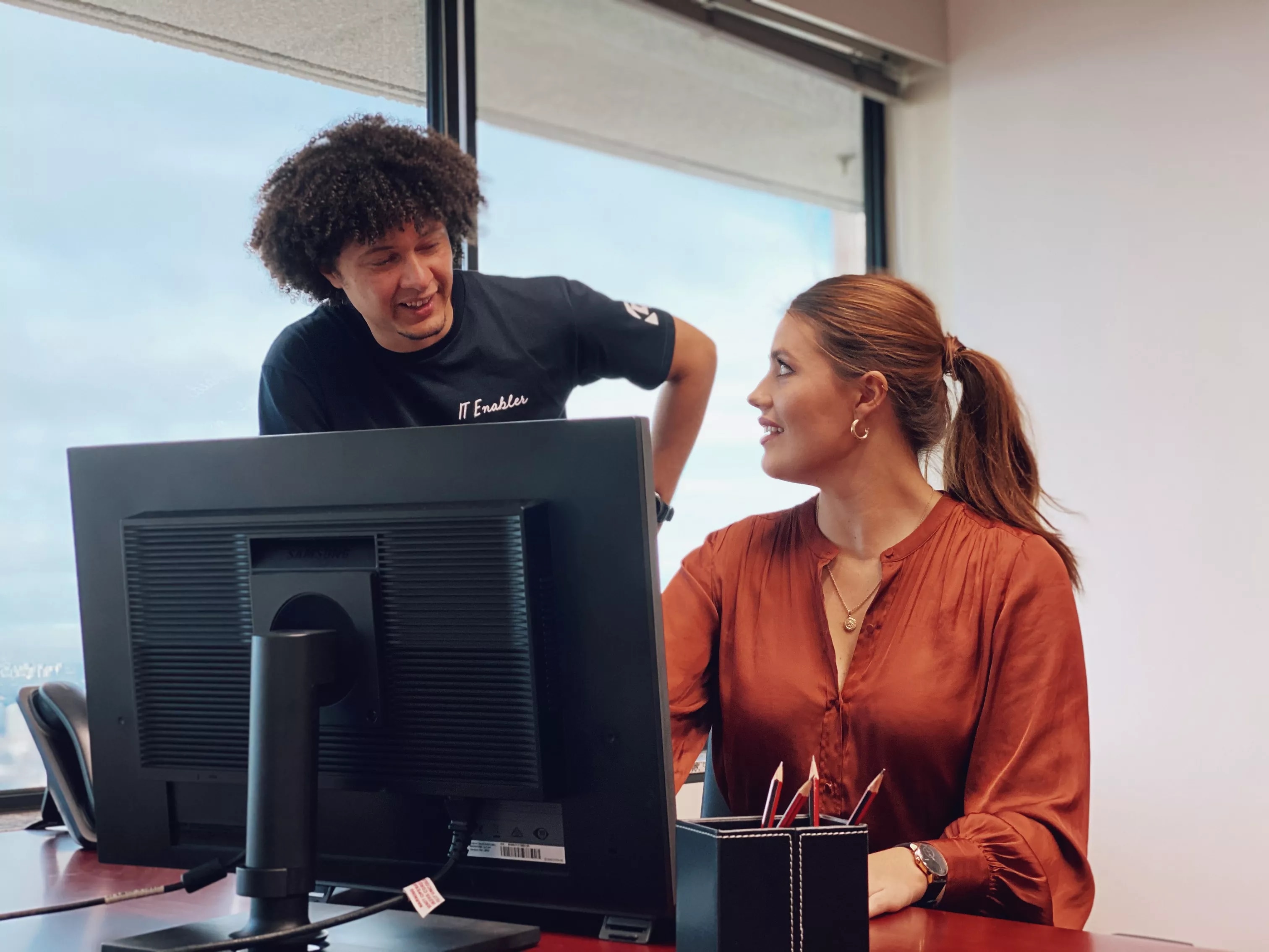 A client receiving help from an IT specialist in Servcorp Southbank Melbourne