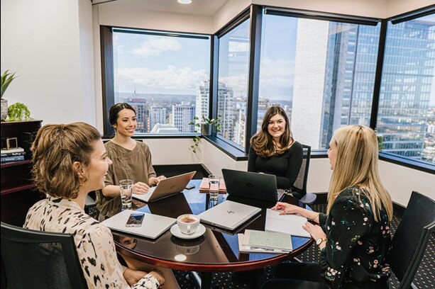 A team of professionals using a meeting room for collaboration.
