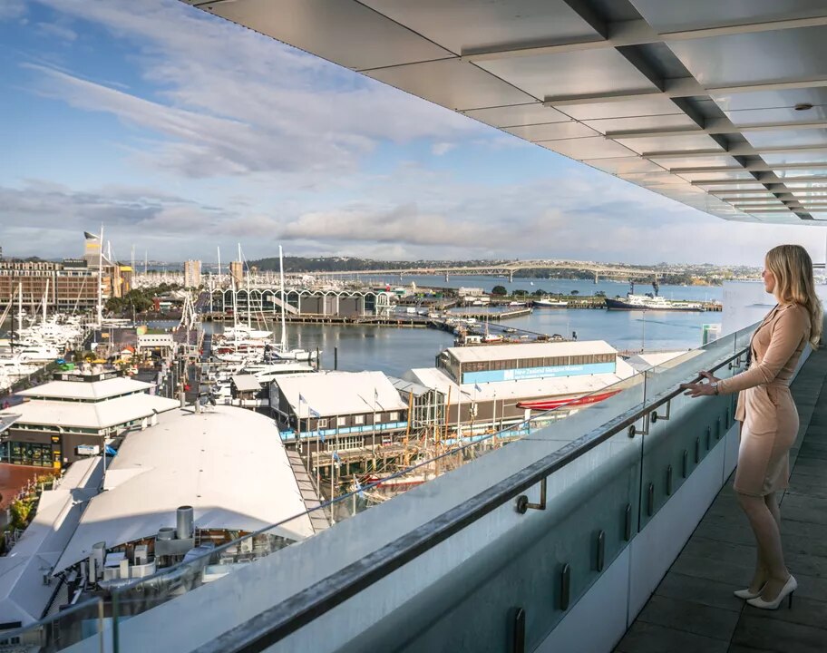A client admiring the views from a balcony in Servcorp 139 Quay Street, Auckland