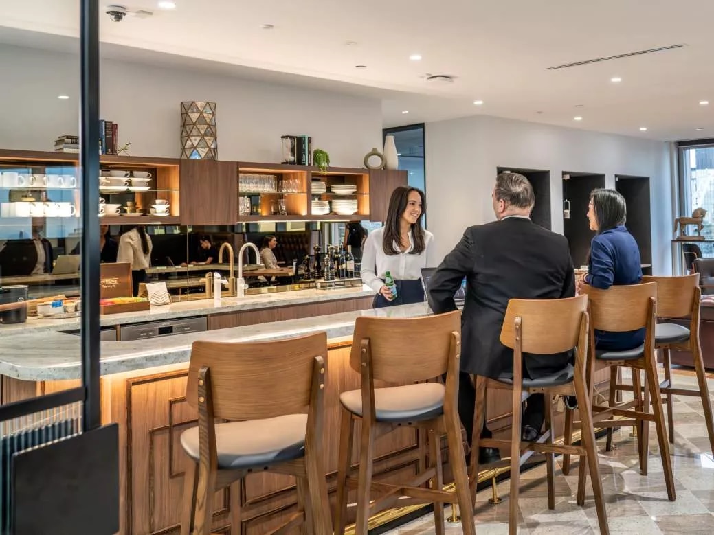 Clients enjoying their time in a modern coworking space break room in Servcorp Chifley Tower