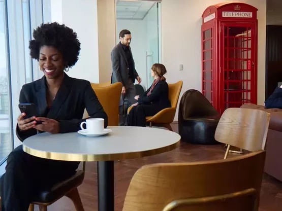 Clients receiving IT related help in a modern coworking space and enjoying the lounge in Servcorp Avaya House, Macquarie Park