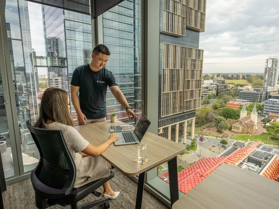 IT specialist helping a client in a Serviced Office in Servcorp 3 Parramatta Square