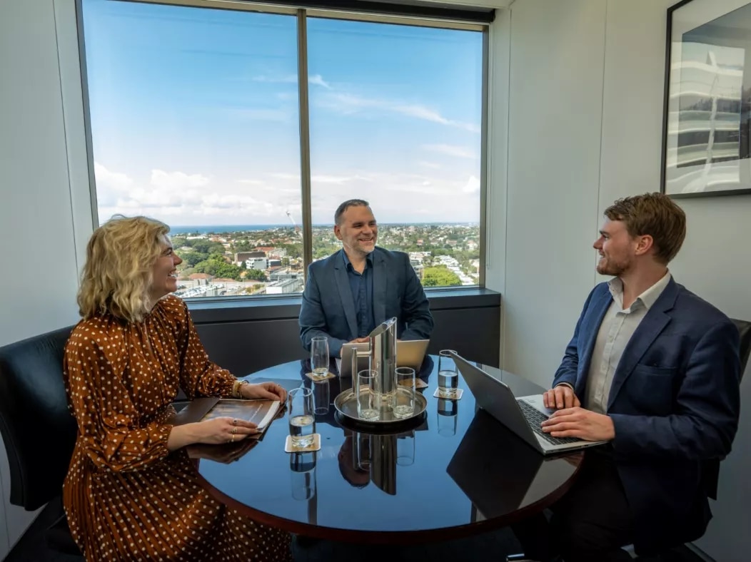 Clients conversing and working in a meeting room at Servcorp Westfield Tower 2