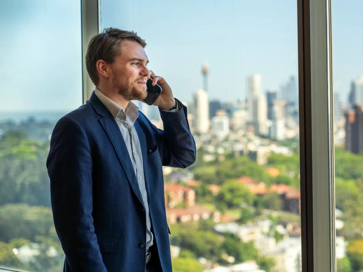 Clients conversing on the phone at a modern co-working space with a nice view at Servcorp Westfield Tower 2