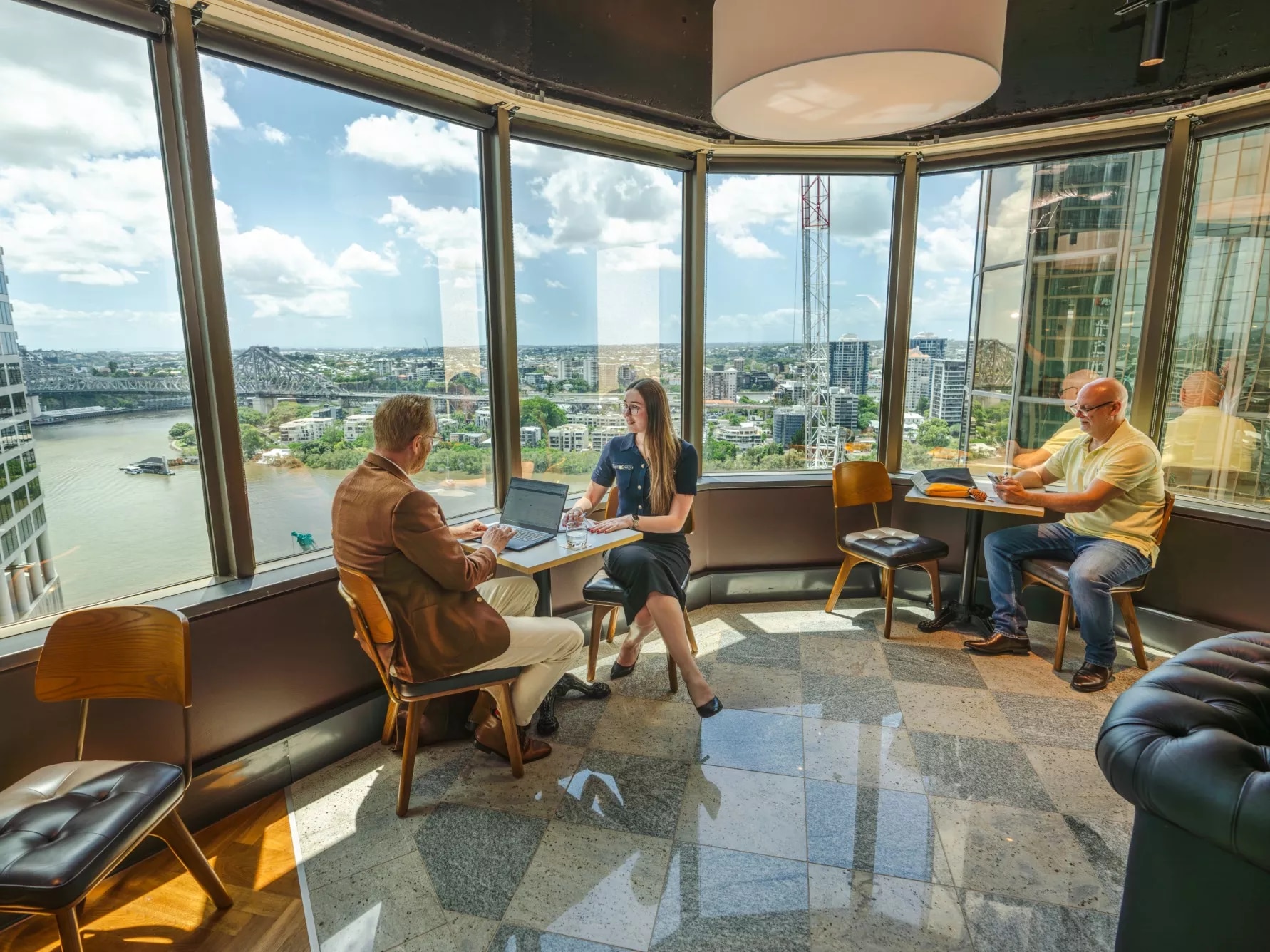 Clients working in a modern coworking space, with impressive views in Servcorp 10 Eagle Street, Brisbane