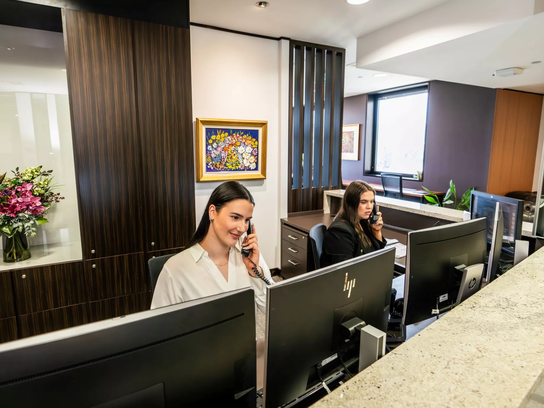 Dedicated receptionists on the phone to clients in Servcorp Reserve Bank Building, Hobart
