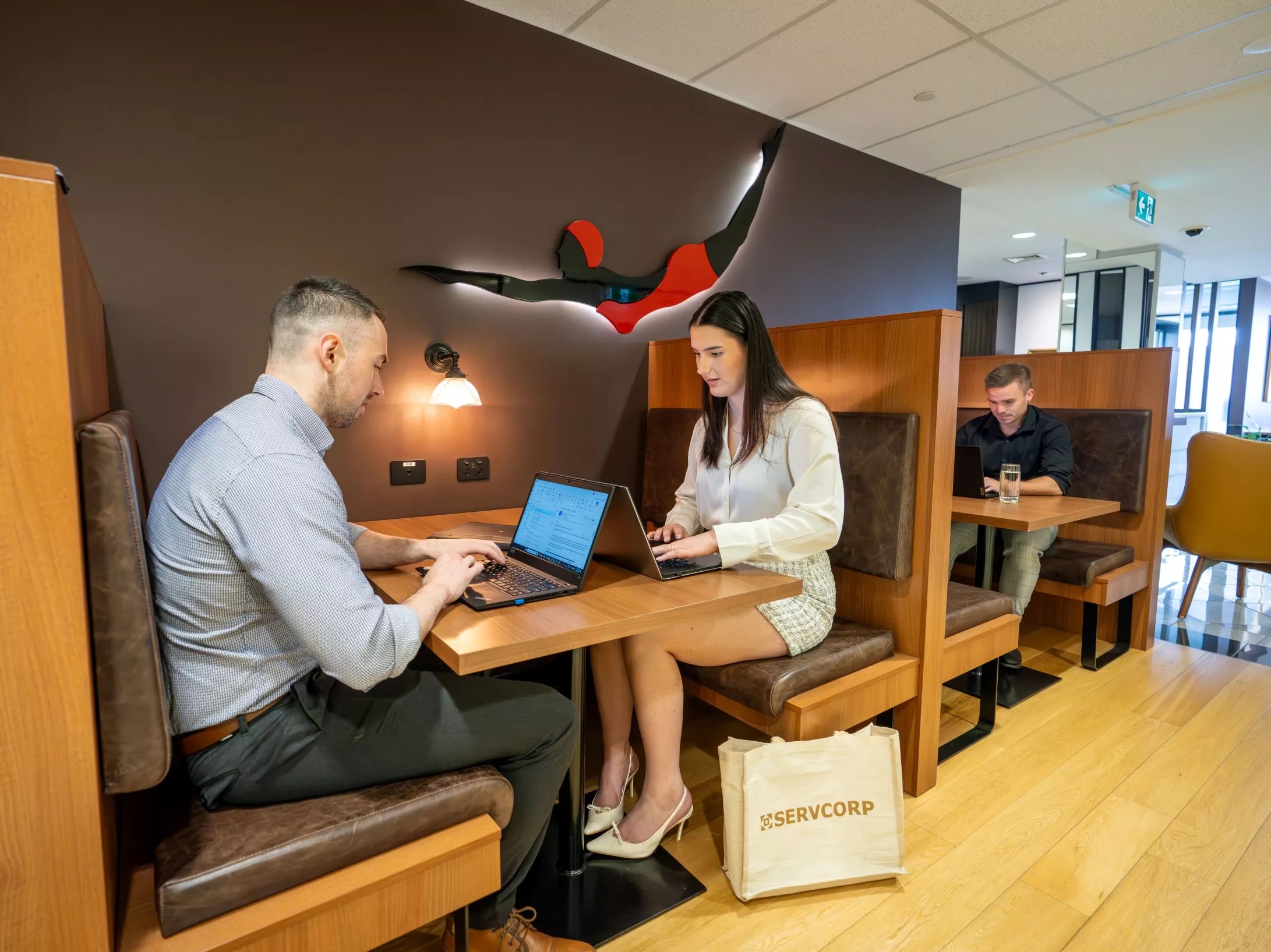 Clients working in a modern coworking booths in Servcorp Reserve Bank Building, Hobart