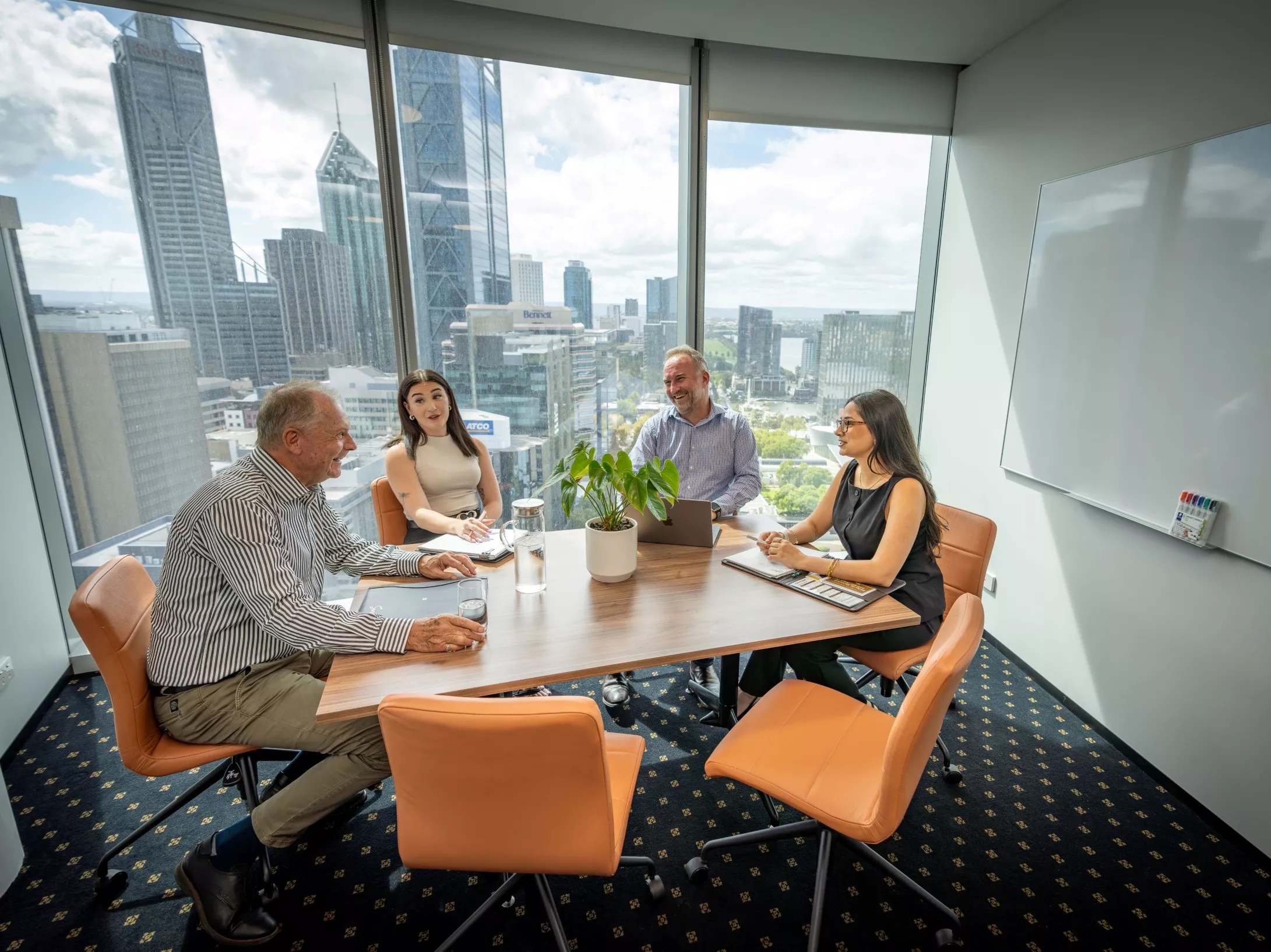 A client talking to her clients in a modern meeting room space with impressive views in Servcorp Capital Square Tower 3 Perth
